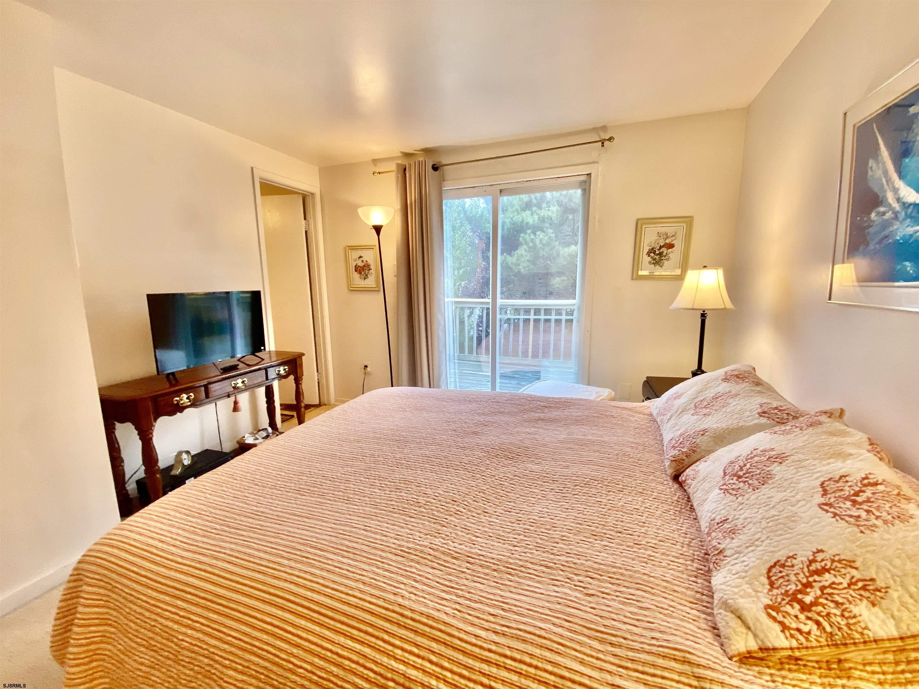 4 Ontario Drive, Unit B Brigantine, NJ 08203 - Photo 18 of 25 a bedroom with a bed and a flat screen tv