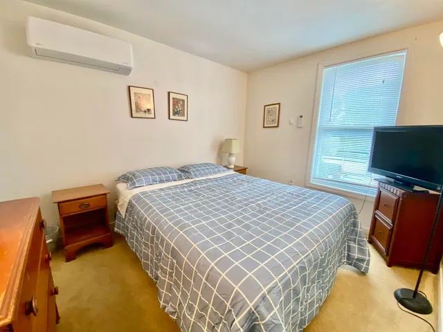 a bedroom with bed and flat screen tv