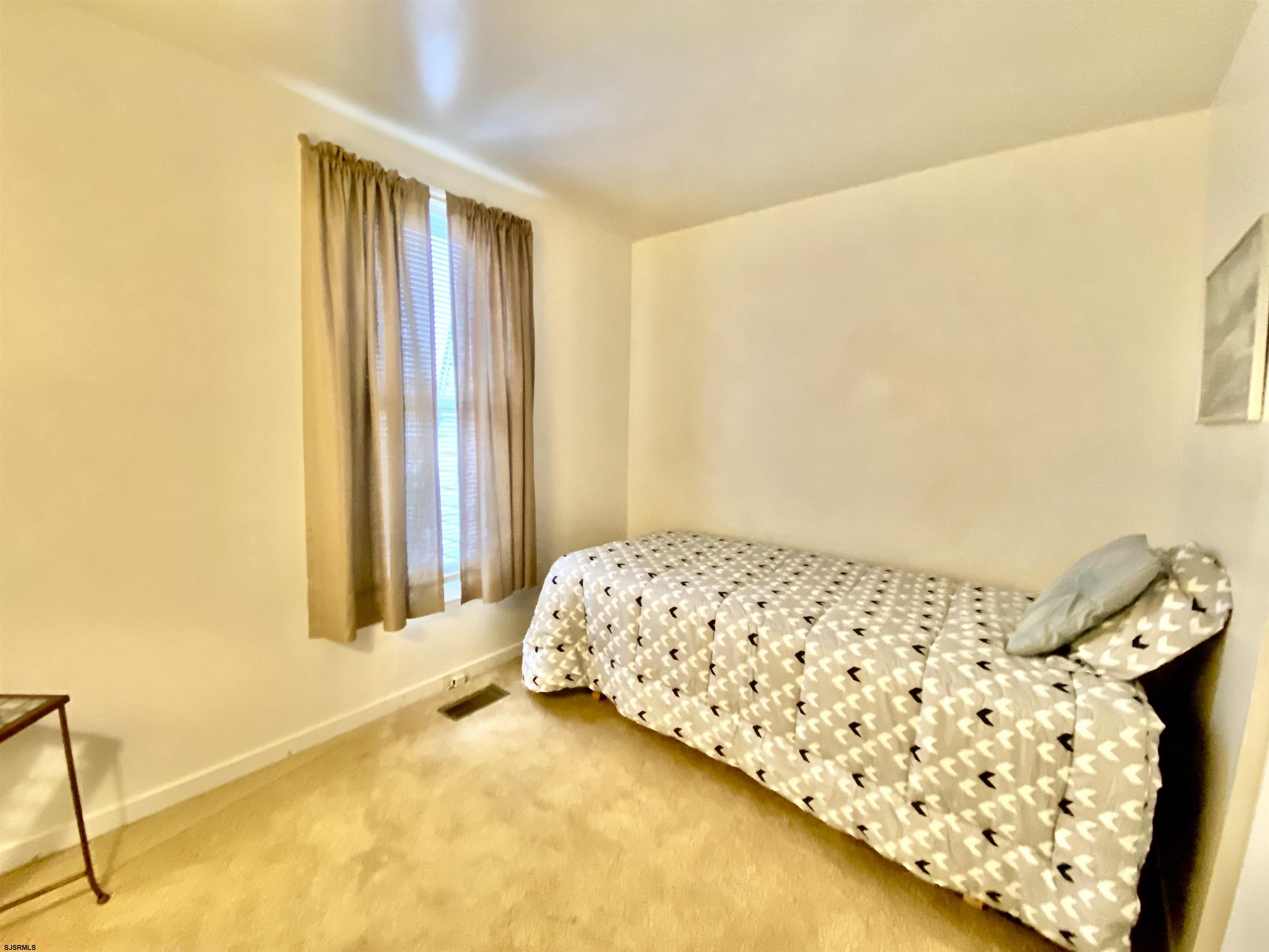 4 Ontario Drive, Unit B Brigantine, NJ 08203 - Photo 21 of 25 a bedroom with a bed and a window