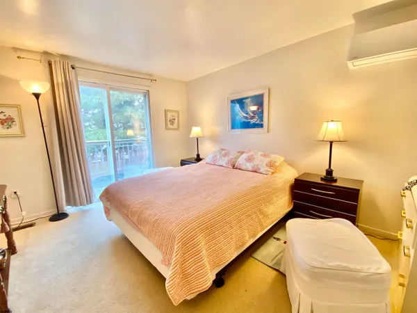 a bedroom with a bed and a night stand