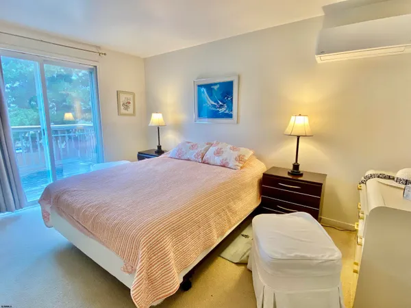 a bedroom with a bed and a lamp