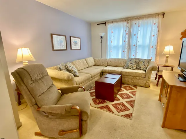 a living room with furniture and a lamp