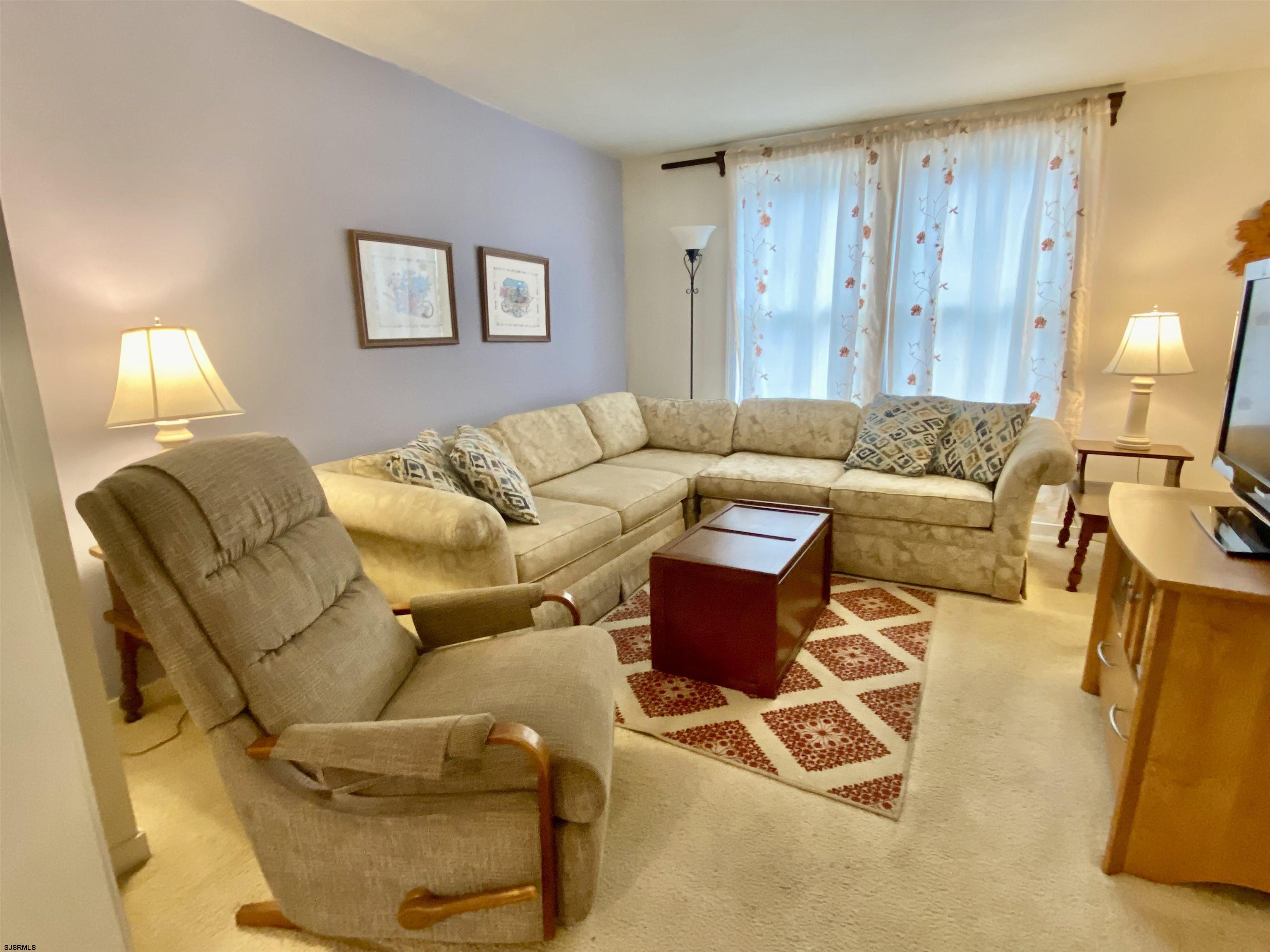 4 Ontario Drive, Unit B Brigantine, NJ 08203 - Photo 4 of 25 a living room with furniture and a lamp