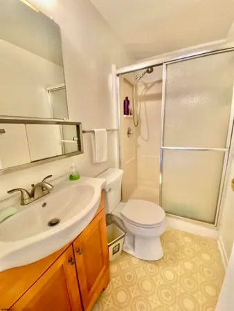 a bathroom with a sink toilet and shower