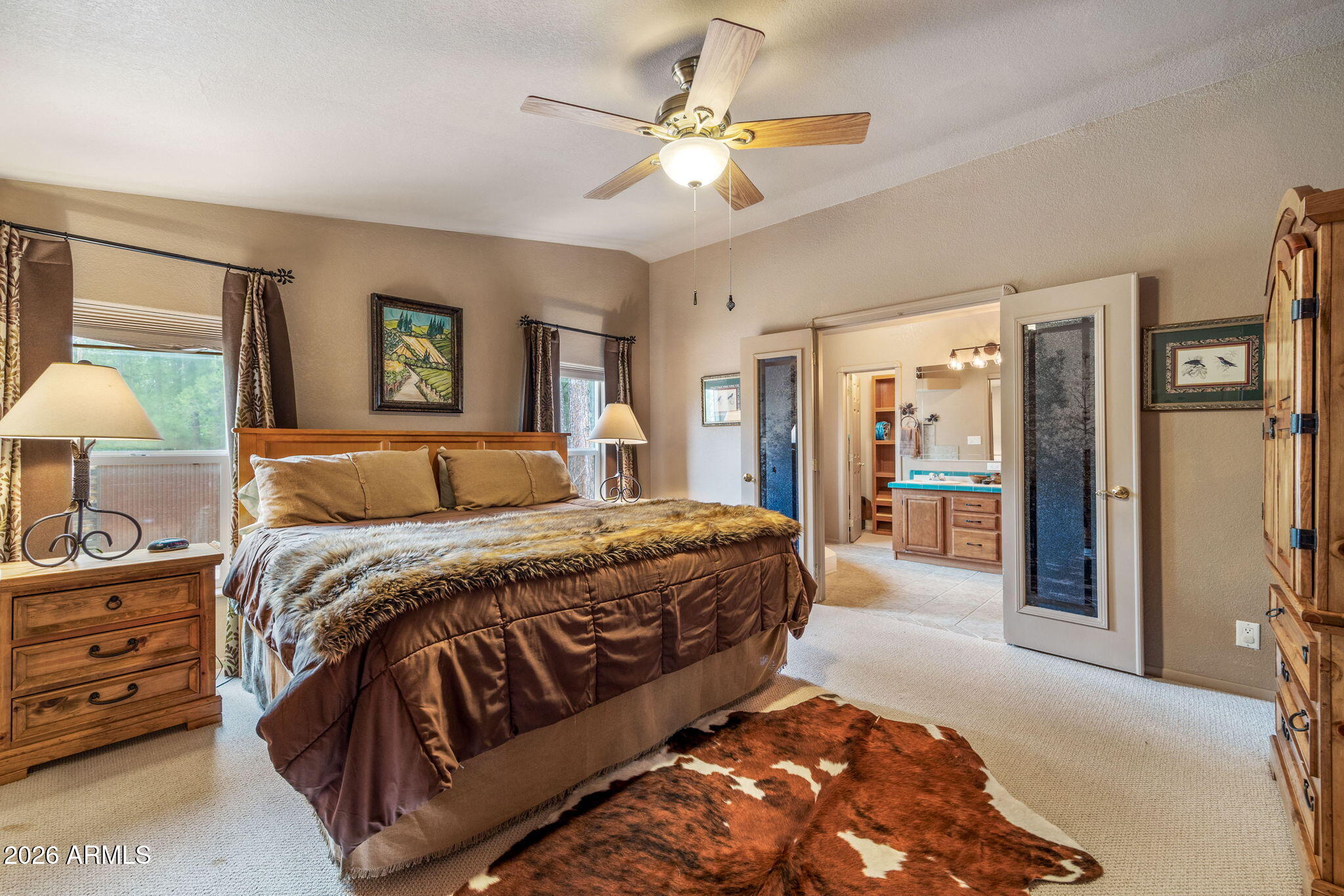 758 Southlake Road Lakeside, AZ 85929 - Photo 65 of 95 a bedroom with a large bed and a chandelier