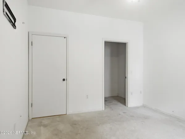 a white toilet sitting next to a small sink and a shower