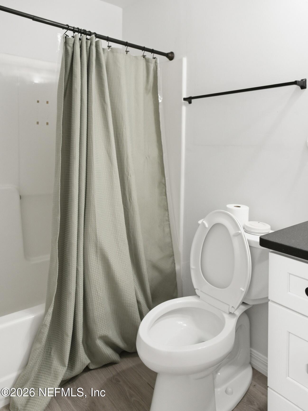 4700 Southwest Archer Road, Unit D27 Gainesville, FL 32608 - Photo 12 of 34 a white toilet sitting next to a small sink and a shower