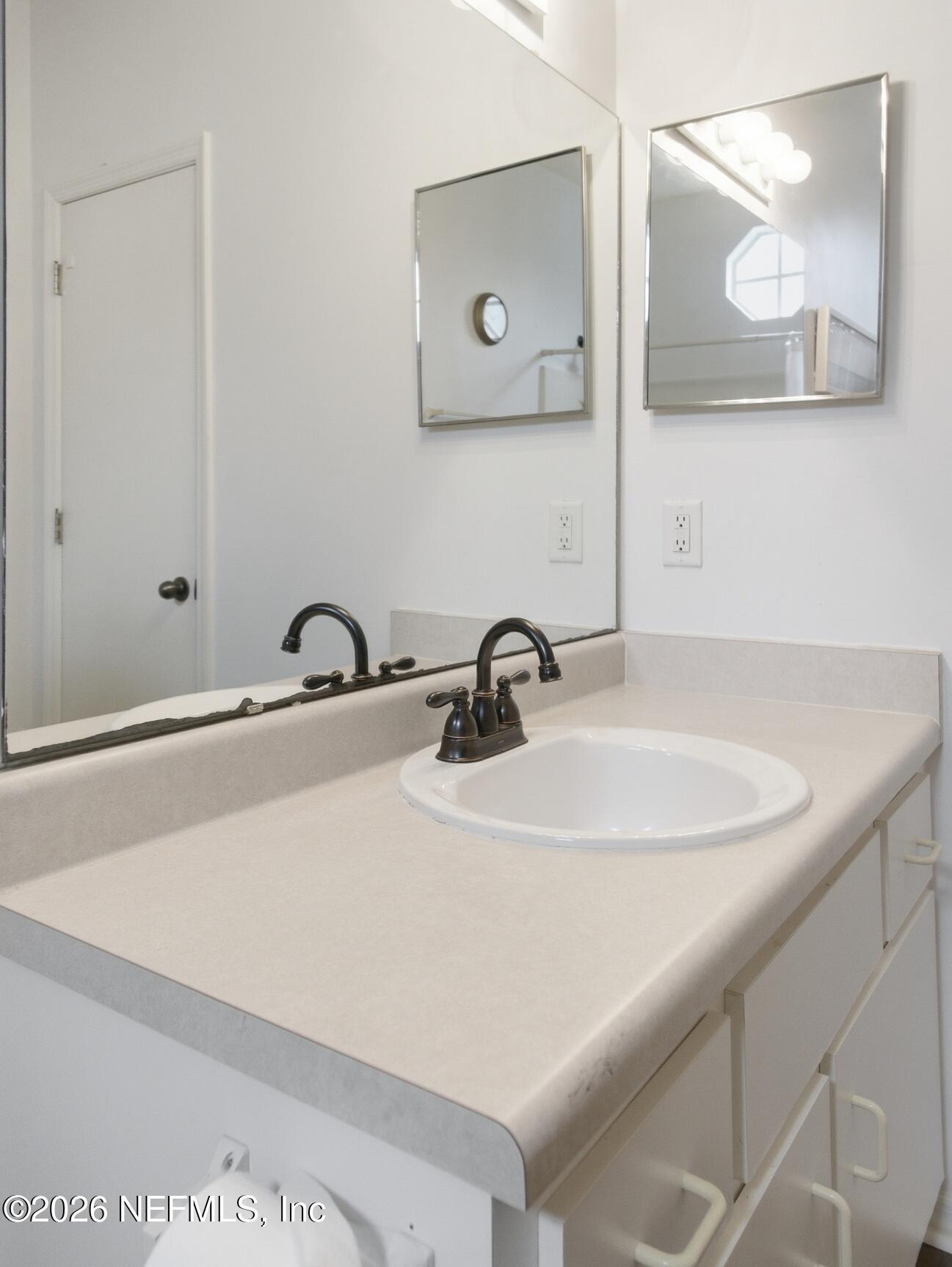 4700 Southwest Archer Road, Unit D27 Gainesville, FL 32608 - Photo 19 of 34 a close view of sink and mirror