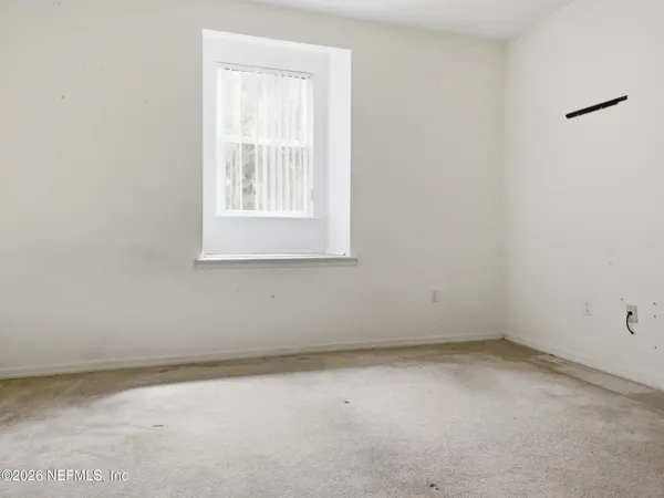 a view of wooden floor and a window
