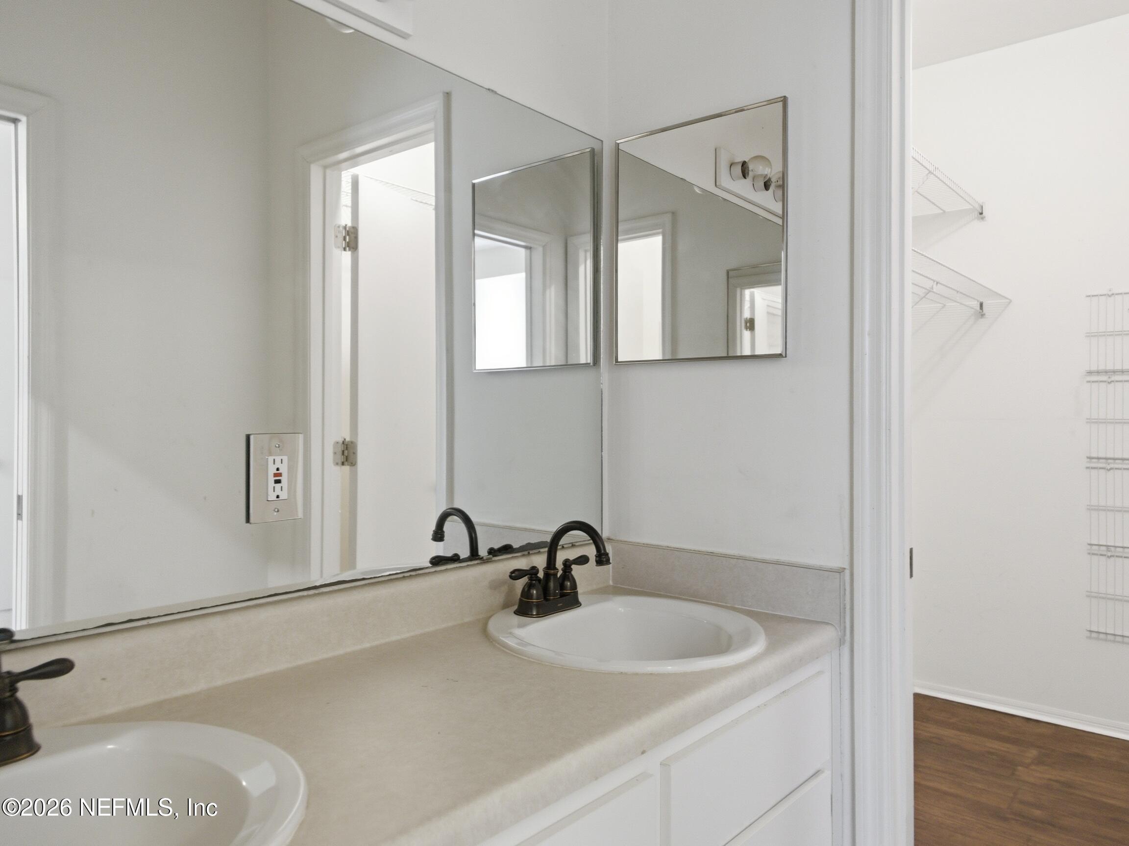 4700 Southwest Archer Road, Unit D27 Gainesville, FL 32608 - Photo 25 of 34 a bathroom with a sink and a mirror