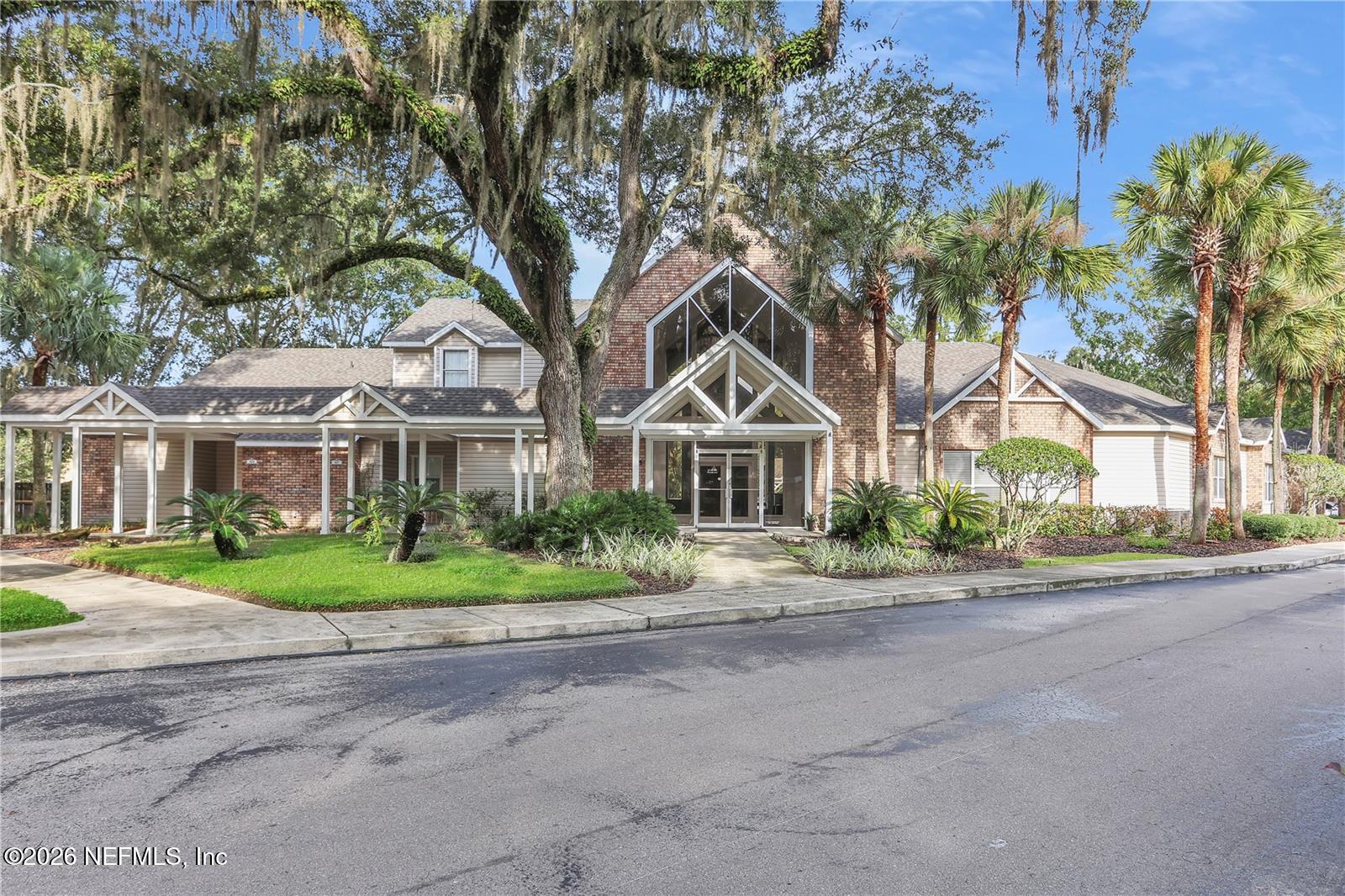 4700 Southwest Archer Road, Unit D27 Gainesville, FL 32608 - Photo 30 of 34 a front view of a house with a yard and potted plants