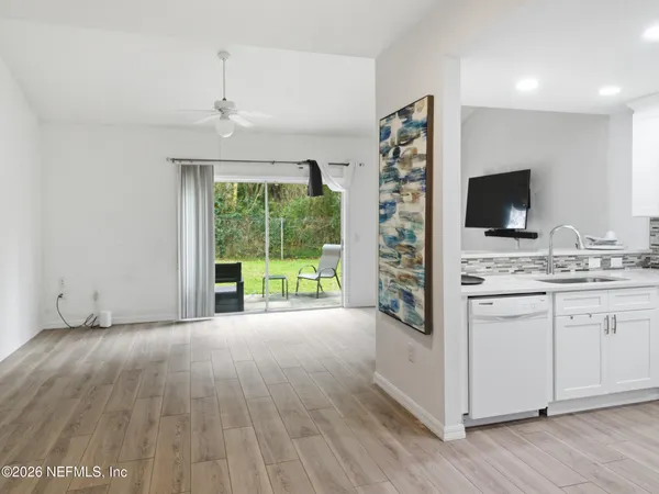 a very nice looking room with a large window and wooden floor