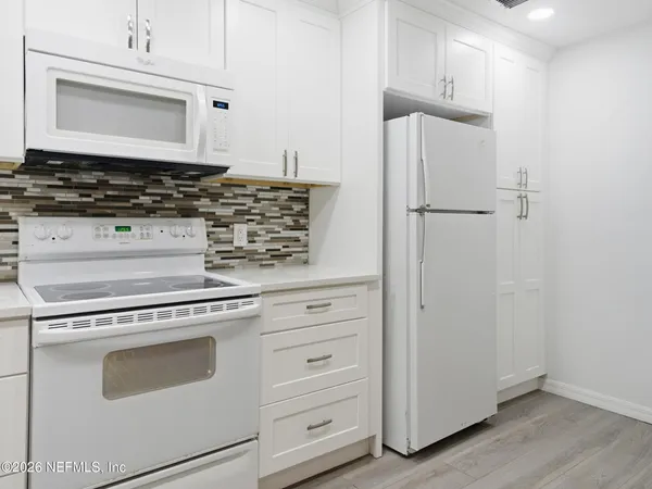 a kitchen with appliances and cabinets