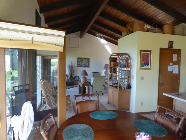 a living room with furniture a flat screen tv and a large window