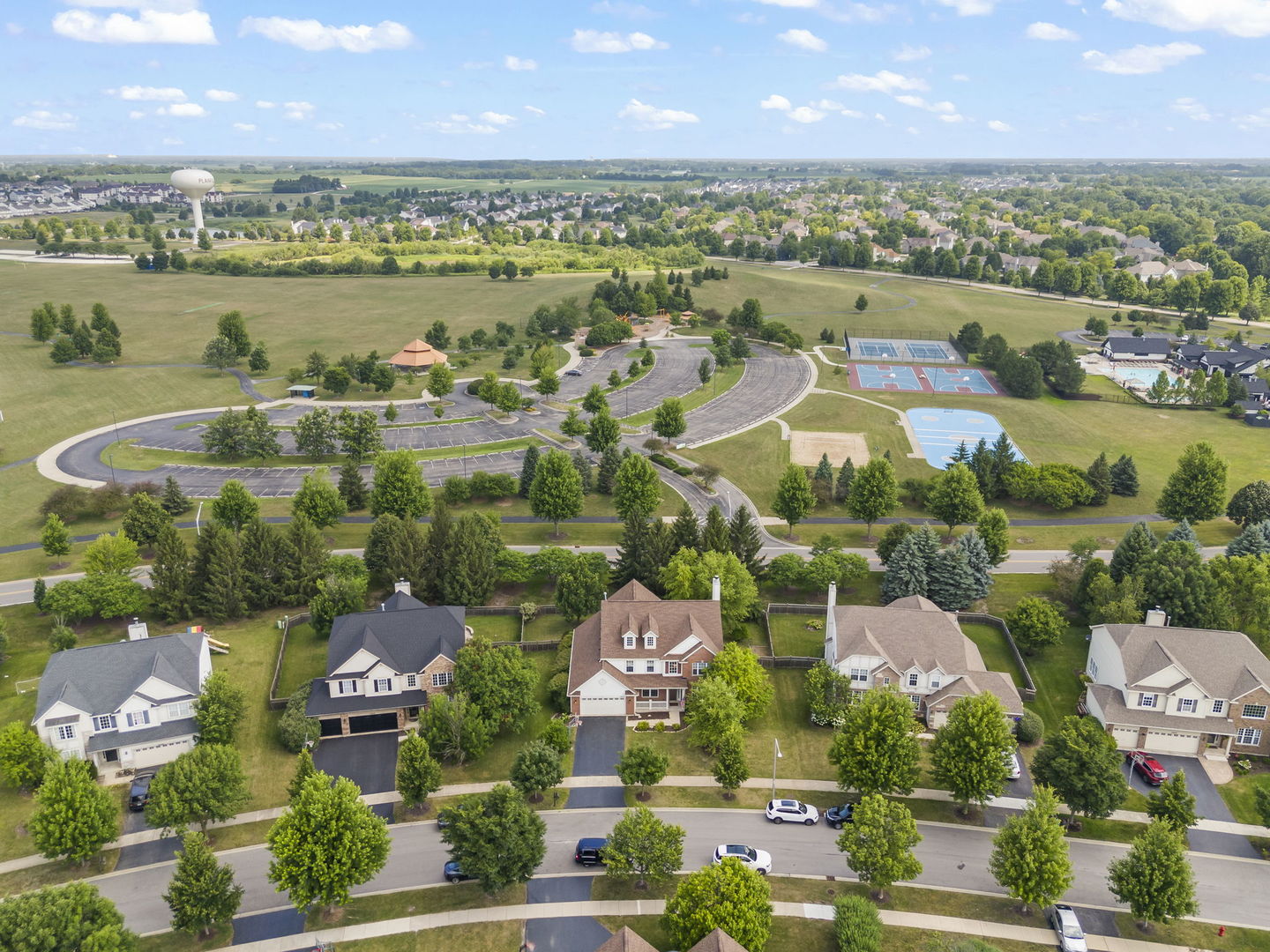 26500 Rustling Birch Way Plainfield, IL 60585 - Photo 30 of 37 an aerial view of a city with lots of residential buildings lake and ocean view