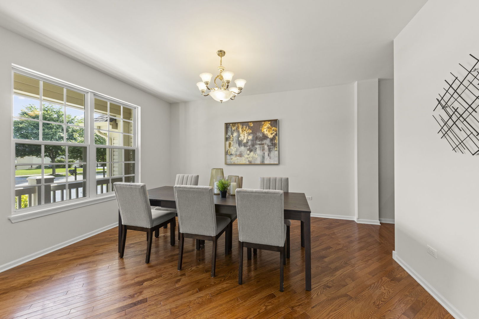 26500 Rustling Birch Way Plainfield, IL 60585 - Photo 4 of 37 a view of a dining room with furniture a chandelier and wooden floor