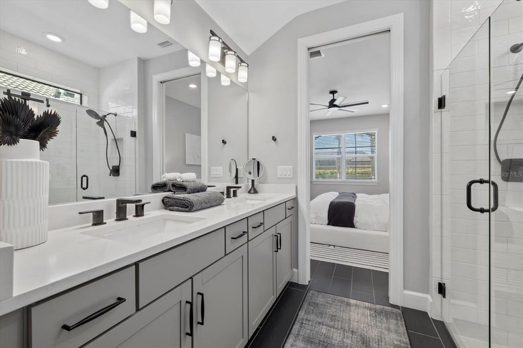 3508 Anchor Bay Trail Lakewood Ranch, FL 34211 - Photo 25 of 74 a spacious bathroom with a double vanity sink a mirror a glass door and shower