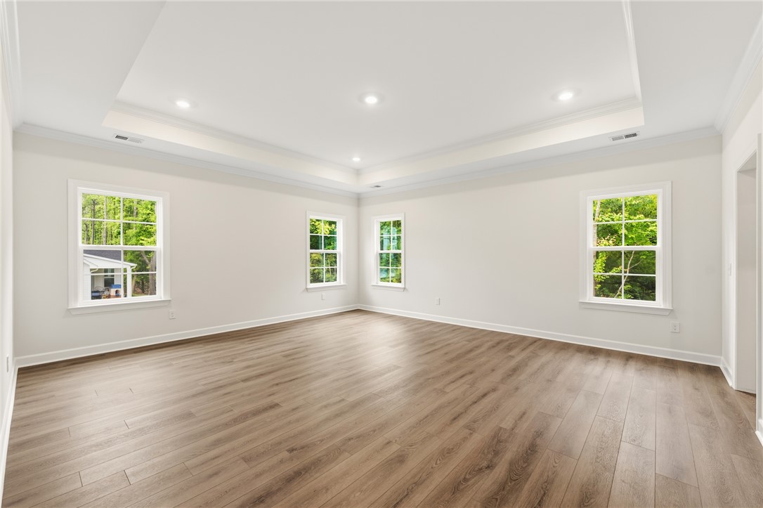 705 Weathered Oak Way Anderson, SC 29621 - Photo 26 of 47 This spacious room features elegant tray ceilings, recessed lighting, and rich hardwood flooring.