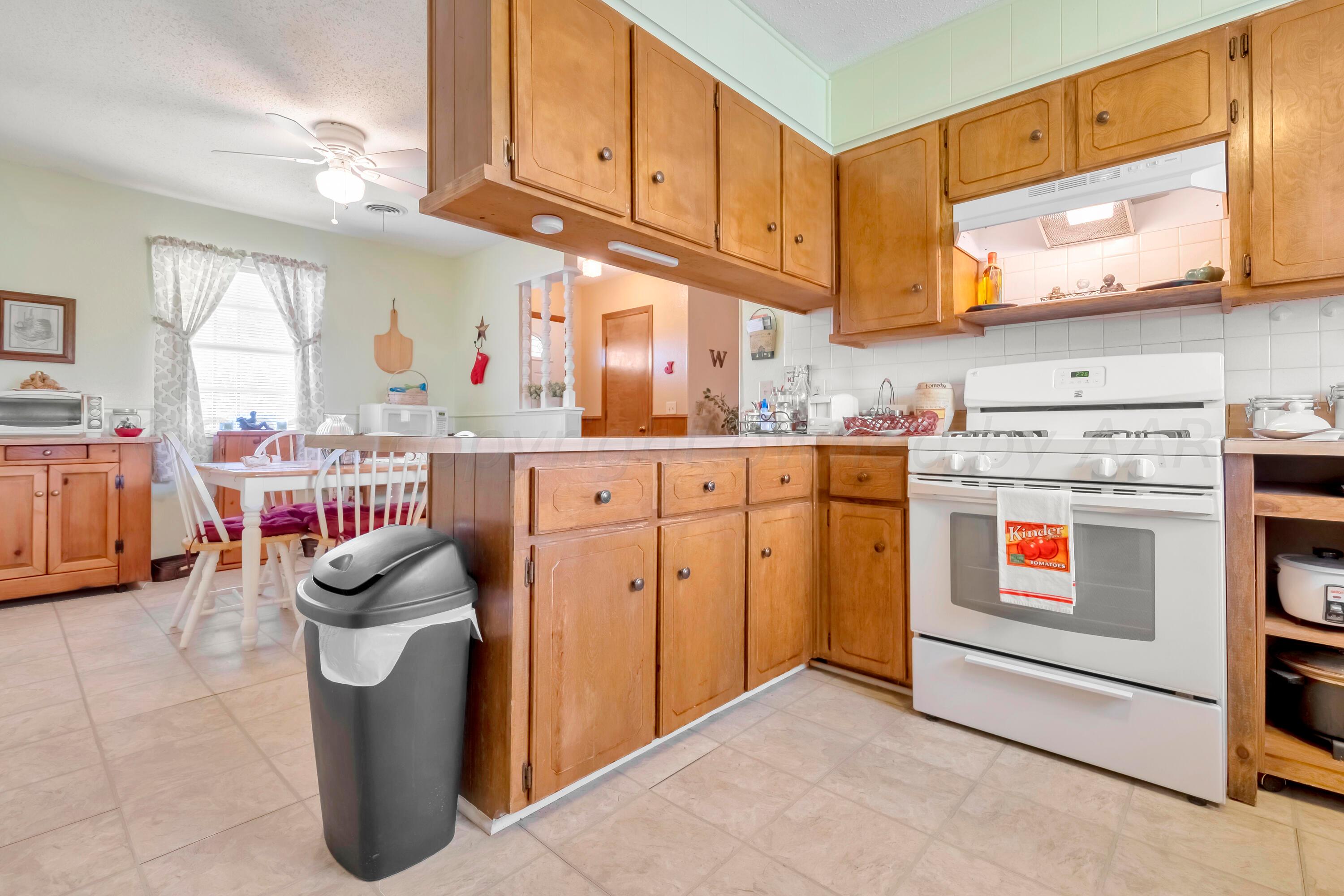 200 West Santa Fe Street Allison, TX 79003 - Photo 11 of 32 a kitchen with stainless steel appliances granite countertop a stove and cabinets