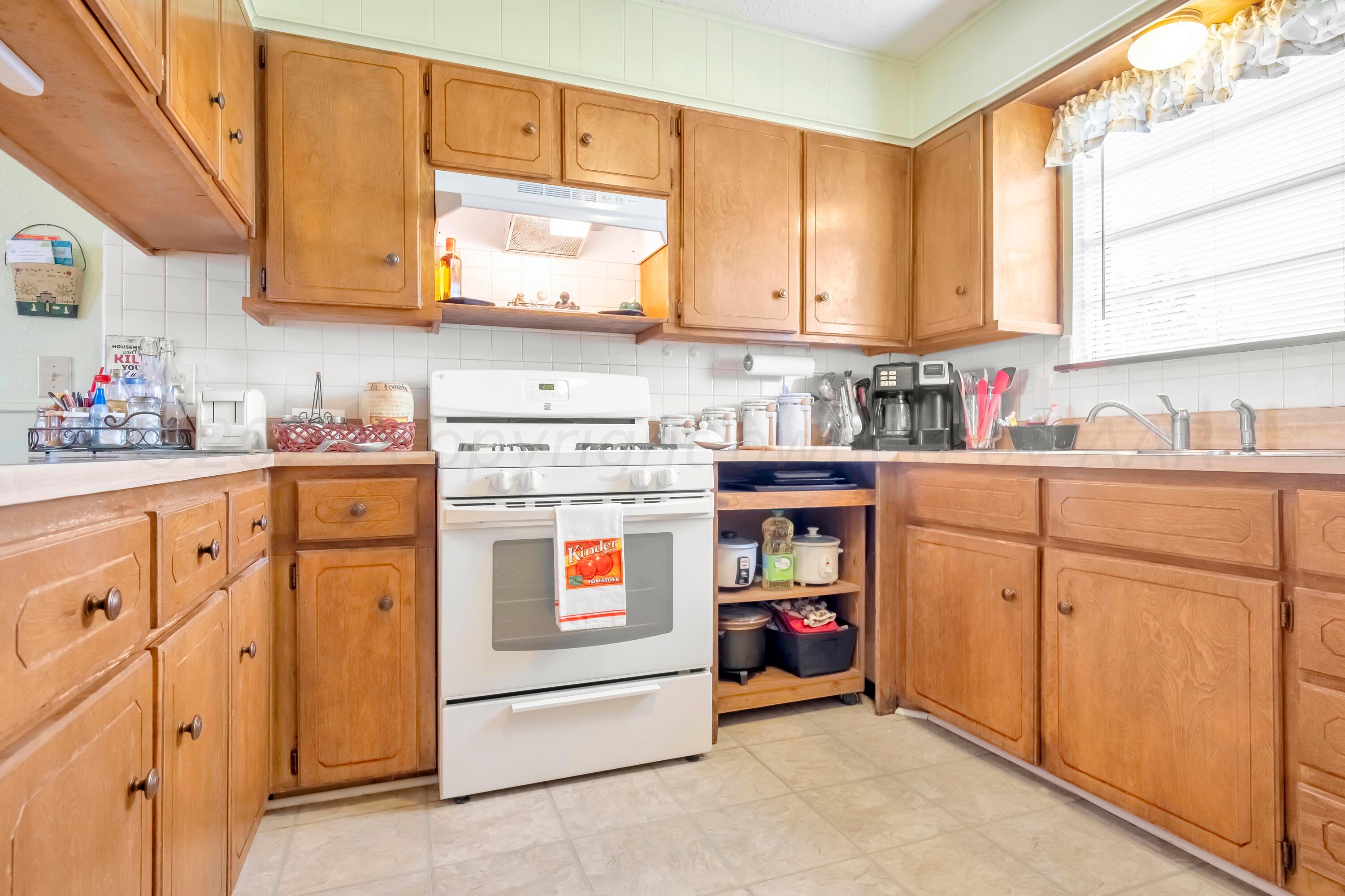 200 West Santa Fe Street Allison, TX 79003 - Photo 12 of 32 a kitchen with stainless steel appliances granite countertop a sink and cabinets