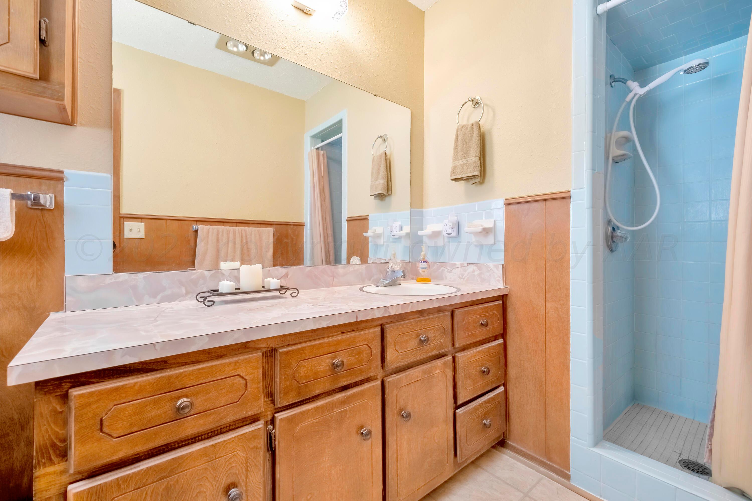 200 West Santa Fe Street Allison, TX 79003 - Photo 15 of 32 a bathroom with a granite countertop sink and a mirror