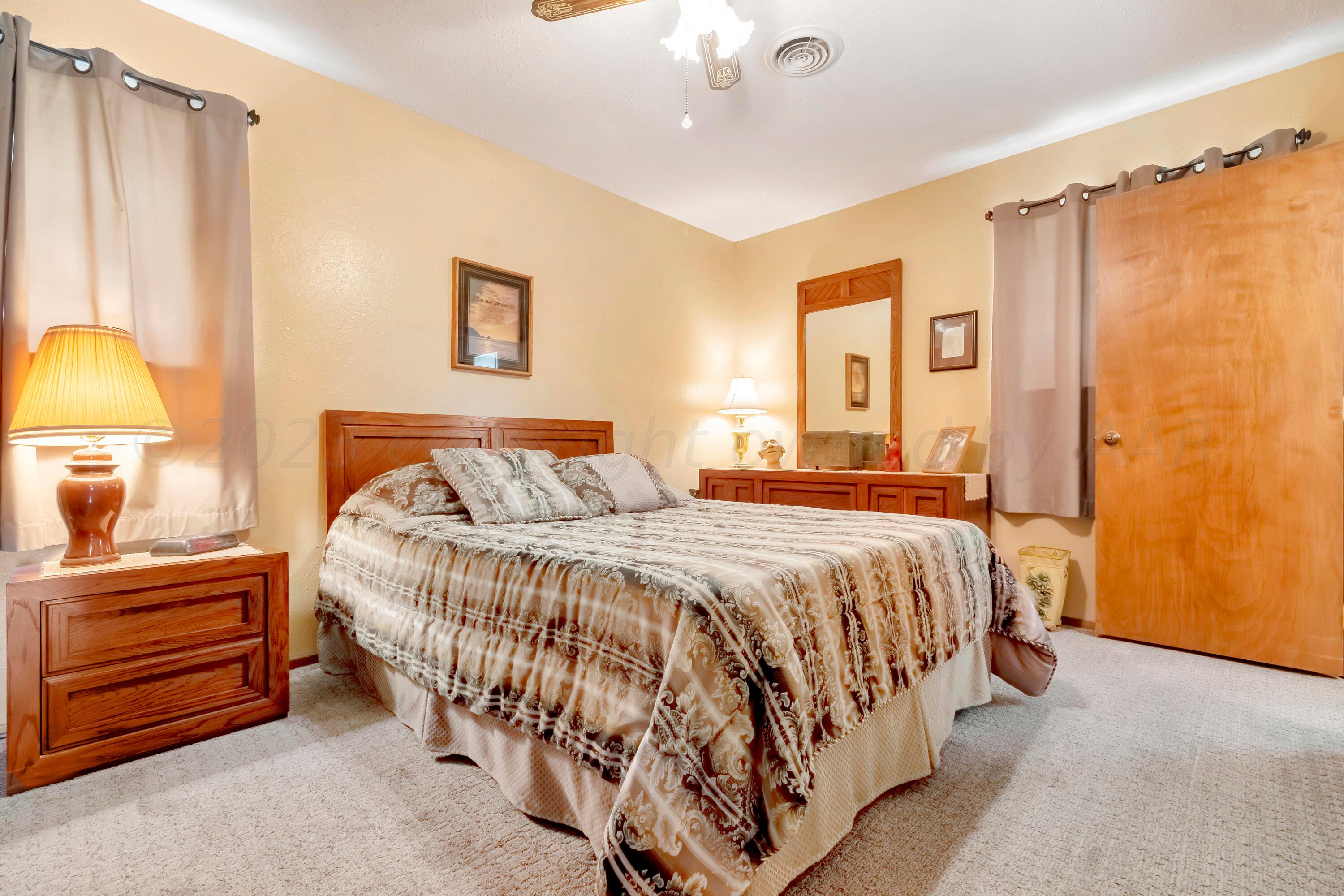 200 West Santa Fe Street Allison, TX 79003 - Photo 16 of 32 a bedroom with a bed and a lamp