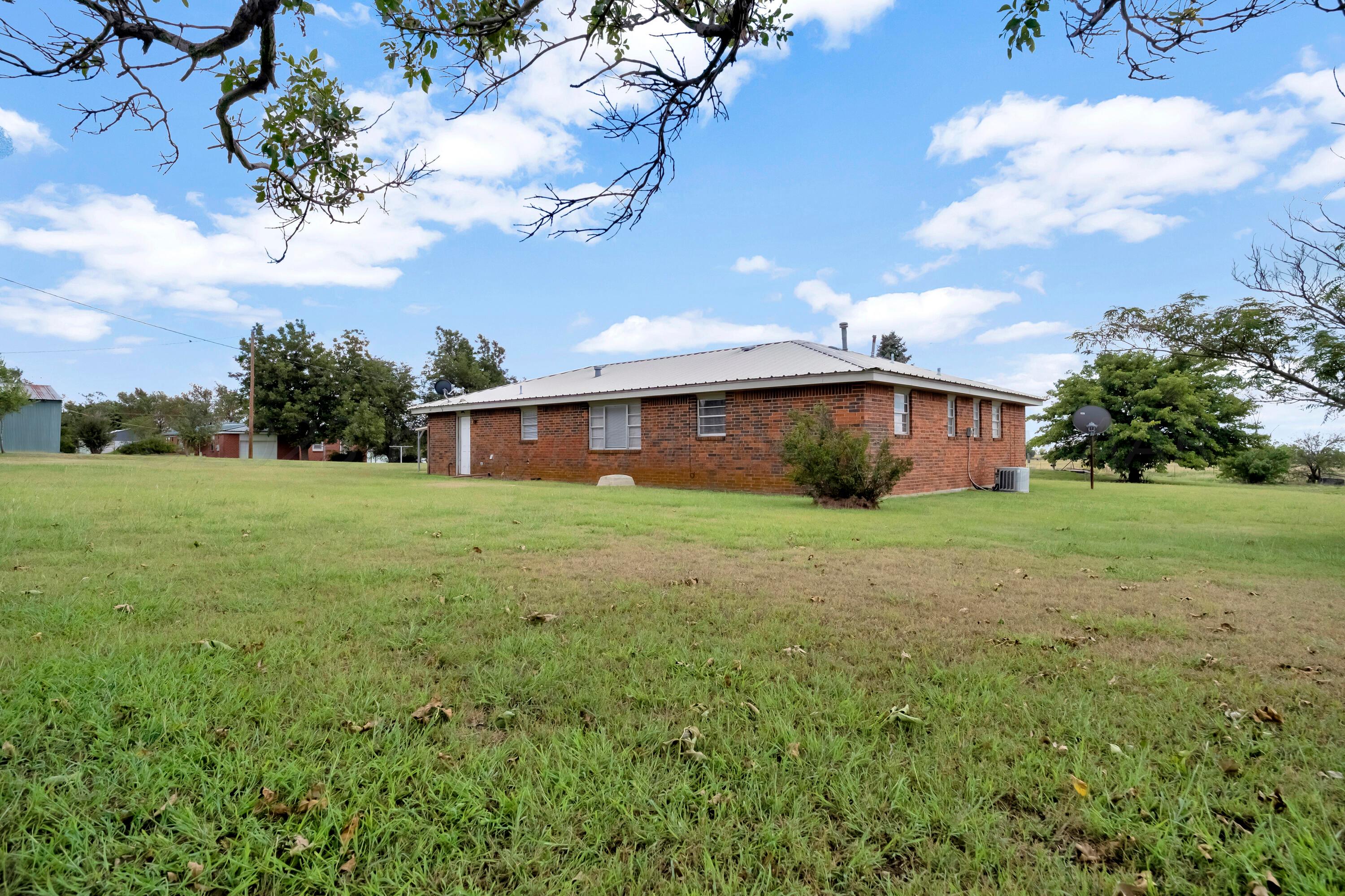 200 West Santa Fe Street Allison, TX 79003 - Photo 26 of 32 a front view of house with yard and trees