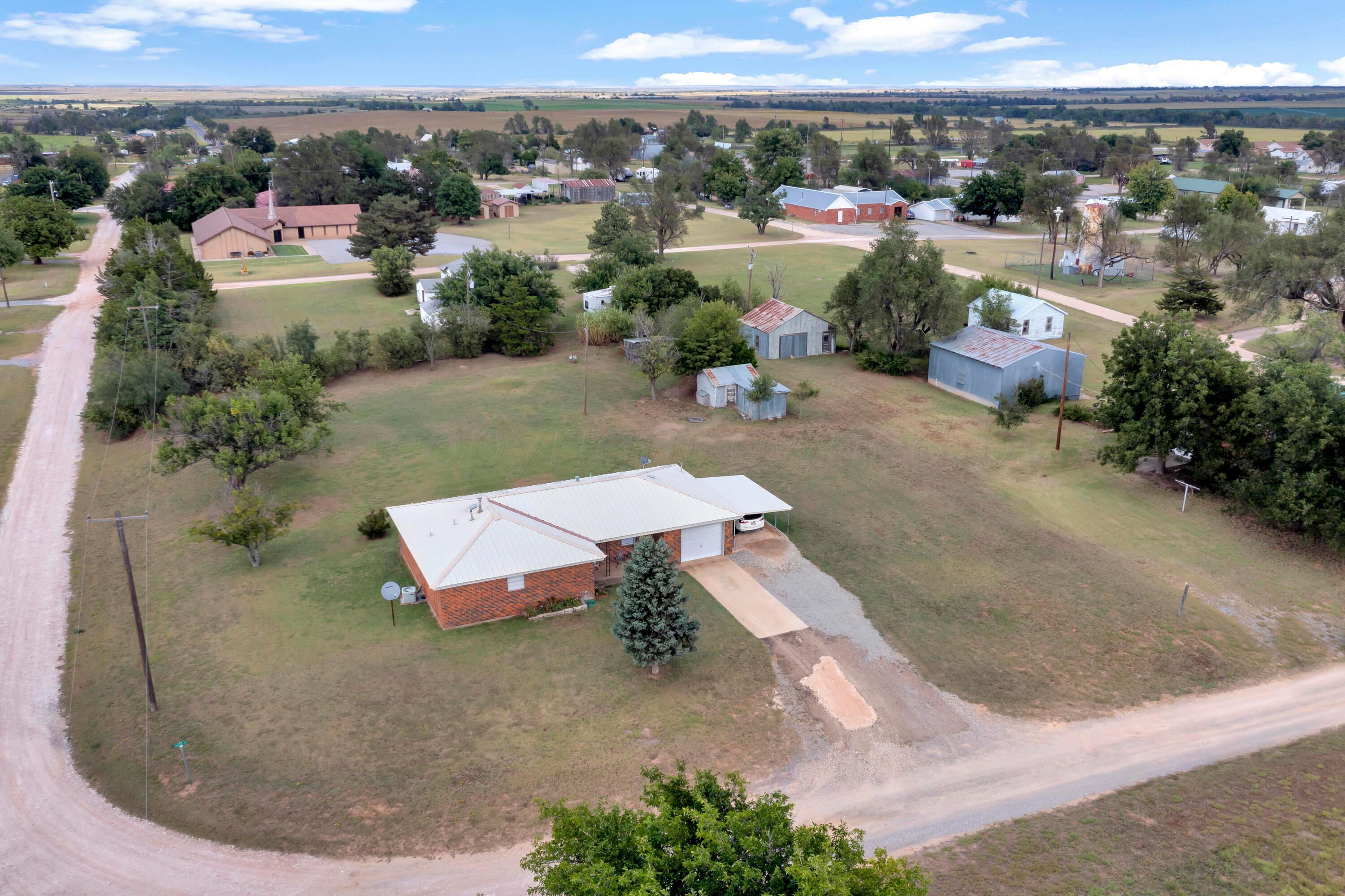 200 West Santa Fe Street Allison, TX 79003 - Photo 27 of 32 an aerial view of a house with a yard and lake view