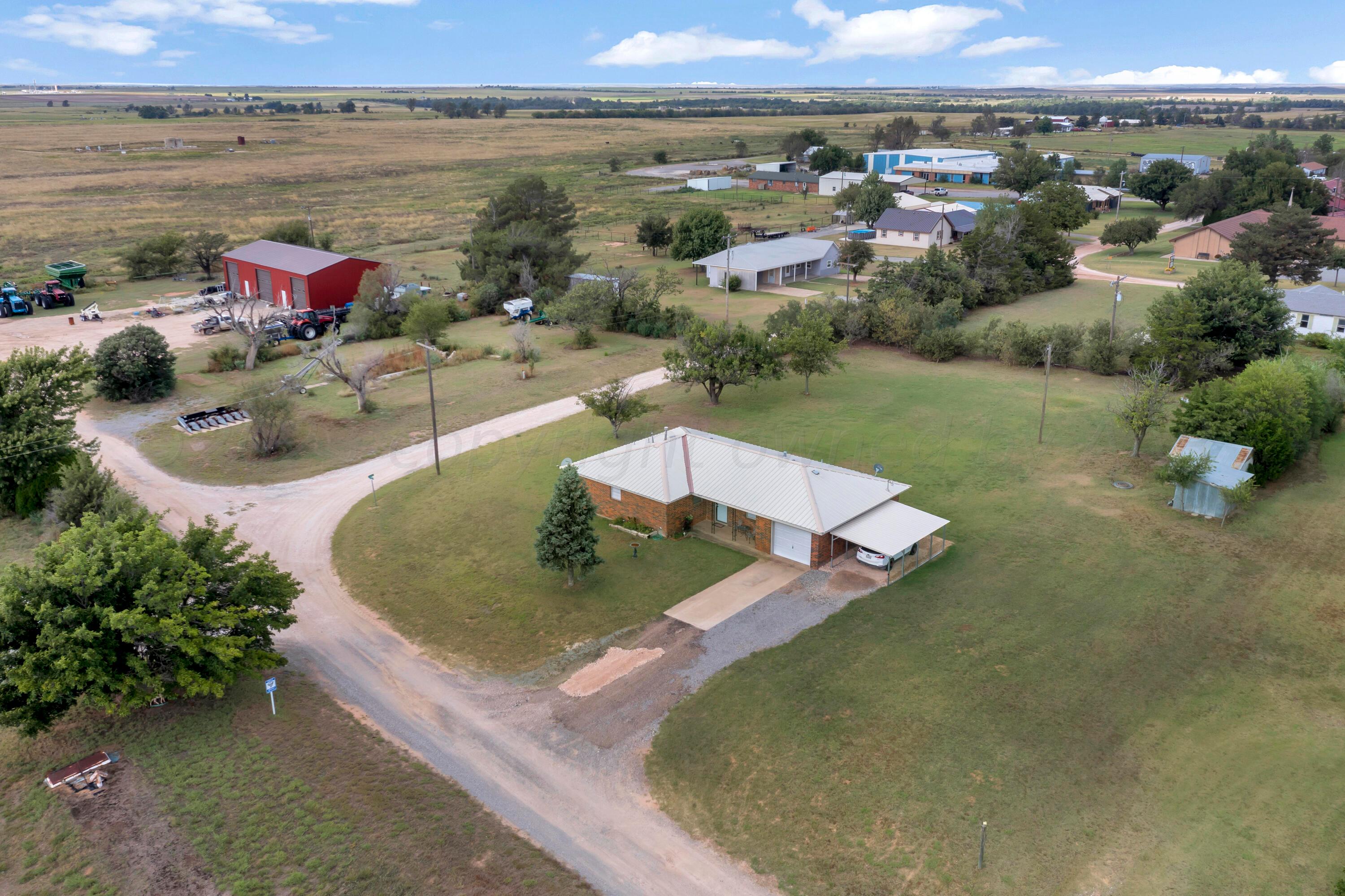 200 West Santa Fe Street Allison, TX 79003 - Photo 28 of 32 an aerial view of a house with a yard and lake view