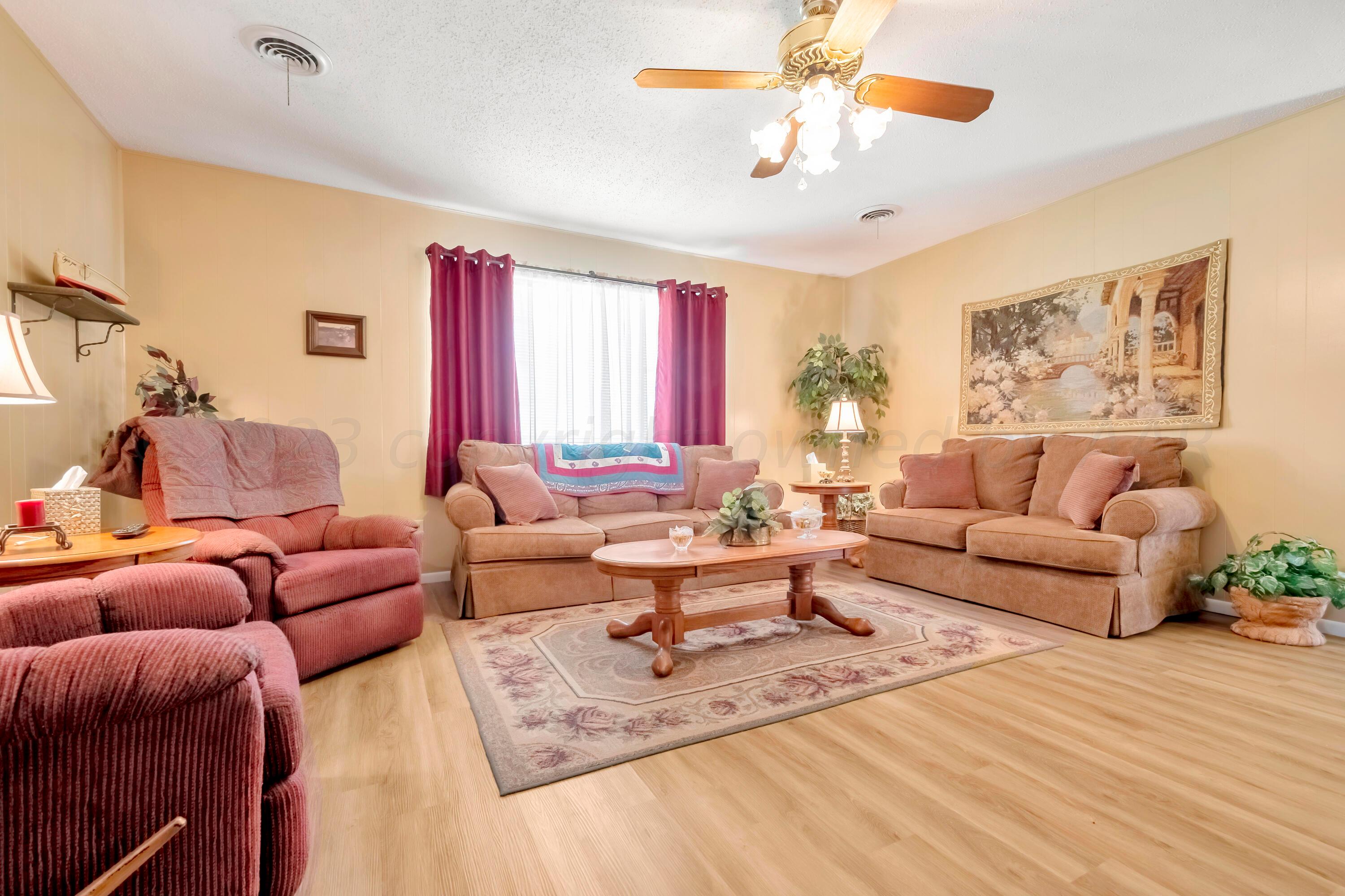 200 West Santa Fe Street Allison, TX 79003 - Photo 6 of 32 a living room with furniture a chandelier and a window