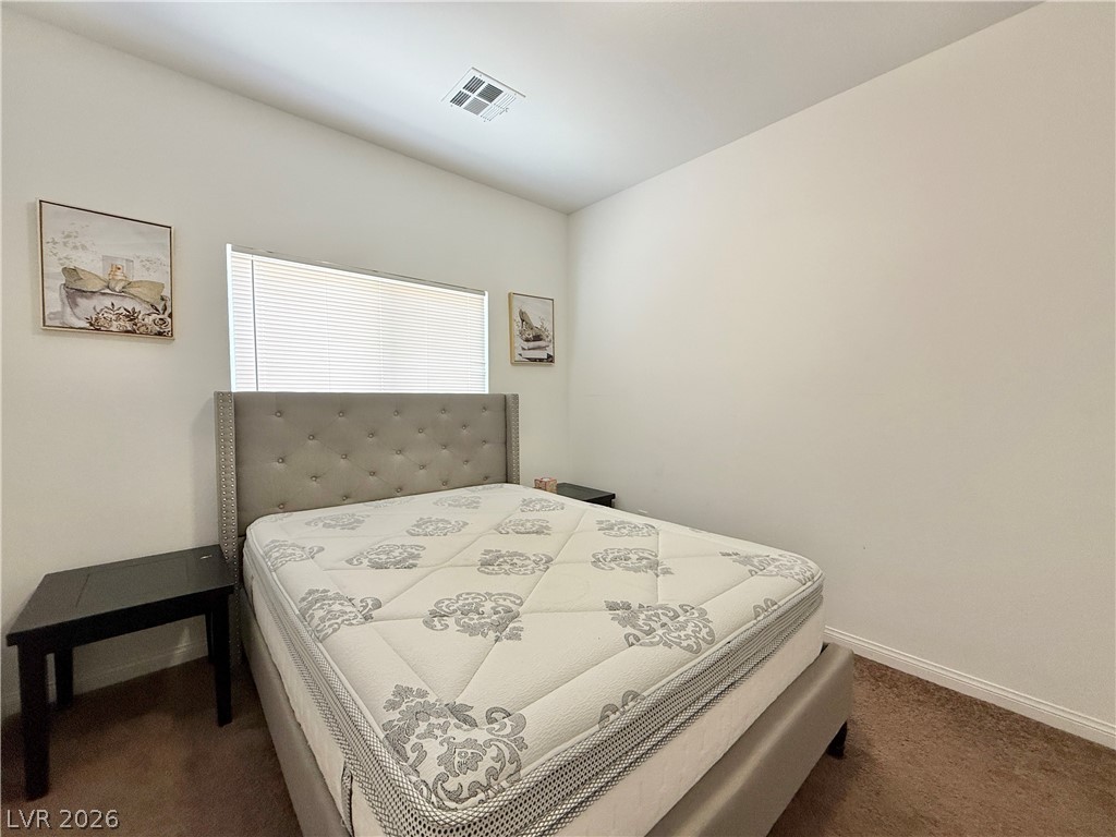 7777 South Westwind Road Las Vegas, NV 89139 - Photo 13 of 46 A well-proportioned bedroom offers comfort with a large window for natural light.