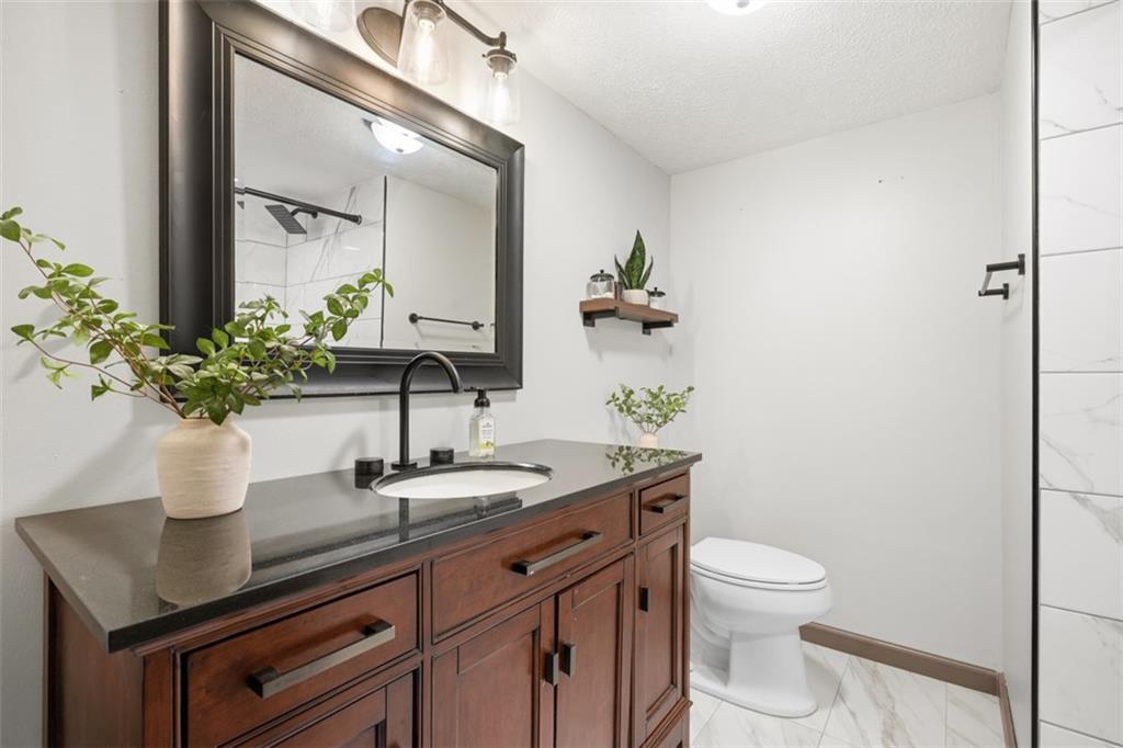 8517 Wittmer Road Pittsburgh, PA 15237 - Photo 33 of 46 a bathroom with a granite countertop sink a toilet and mirror