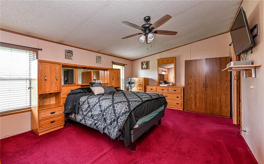 307 Hungarian Road Slippery Rock, PA 16057 - Photo 12 of 34 a bedroom with a bed and a chandelier