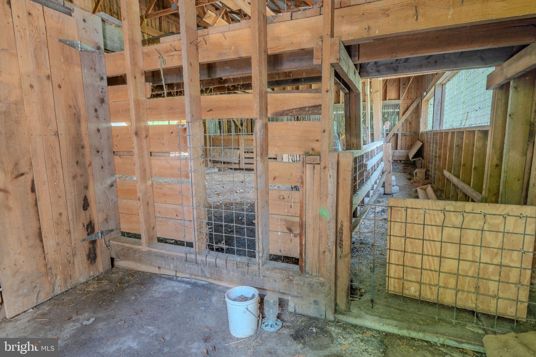 1520 Lingle Valley Road Milroy, PA 17063 - Photo 66 of 144 Rustic barn interior with wooden stalls.
