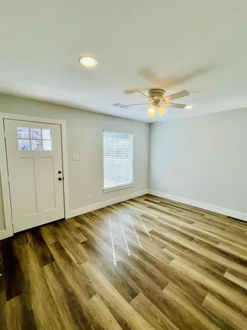 an empty room with wooden floor and closet