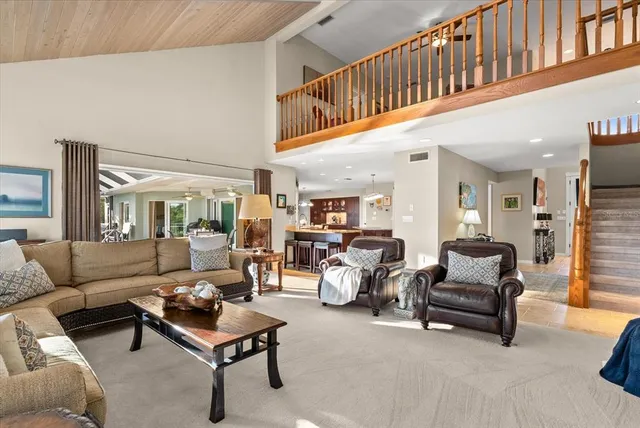 a kitchen with stainless steel appliances granite countertop a table chairs sink and cabinets