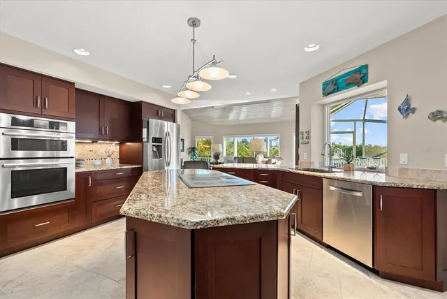 a dining room with furniture a chandelier and window
