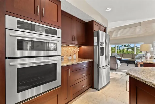 a spacious bedroom with a bed and glass walk in closet