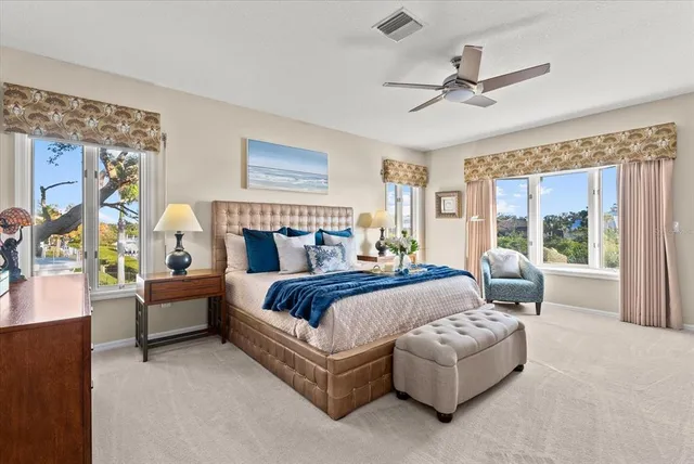 a bathroom with a granite countertop double vanity sink a mirror and a window
