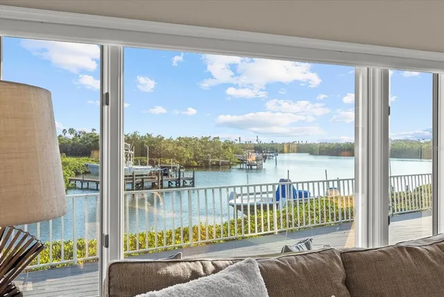 a spacious bedroom with a bed and glass window