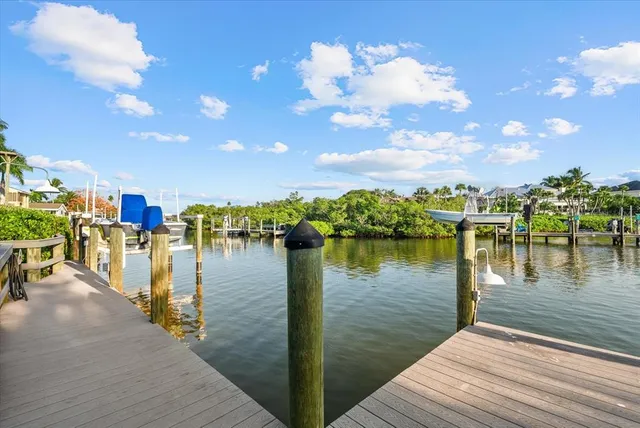 an aerial view of a house with garden space and lake view