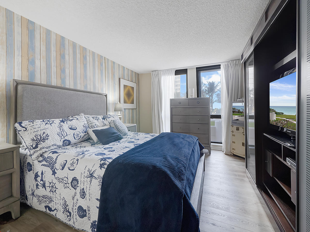 5380 North Ocean Drive, Unit 2E Singer Island, FL 33404 - Photo 14 of 30 a bed room with a bed and a television