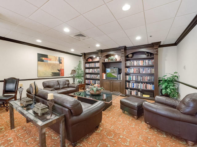 5380 North Ocean Drive, Unit 2E Singer Island, FL 33404 - Photo 27 of 30 a living room with furniture a rug and a bookshelf