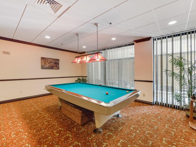 5380 North Ocean Drive, Unit 2E Singer Island, FL 33404 - Photo 28 of 30 a room with pool table and a chandelier