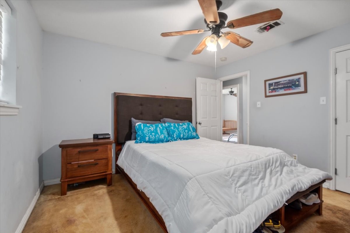 23011 Bayleaf Drive Spring, TX 77373 - Photo 16 of 22 a bedroom with a bed and a chandelier