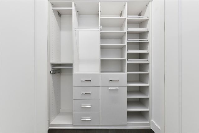 a view of walk in closet with empty racks
