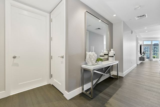 a room with pool table and wooden floor