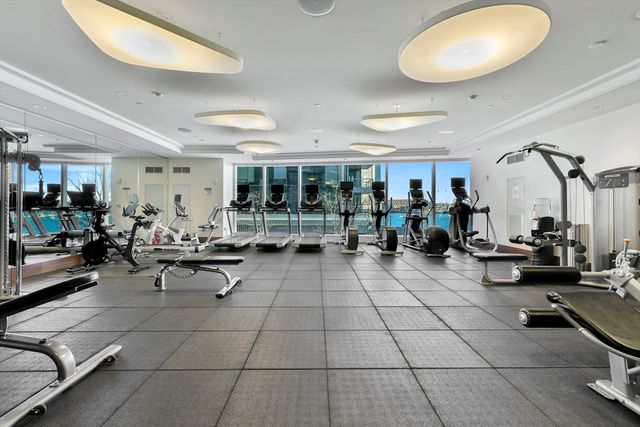 a living room with lots of furniture a rug and white walls