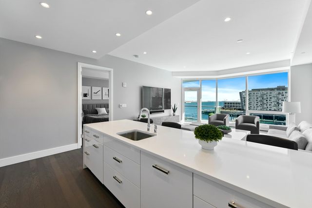 a large white kitchen with a large window