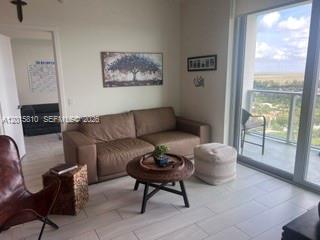 2000 Metropica Way, Unit 1902 Sunrise, FL 33323 - Photo 3 of 7 a living room with furniture and a rug